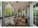 Spacious screened-in porch, great for entertaining, with views of the surrounding nature at 3030 Heatherstone Dr, Cumming, GA 30041