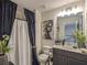 Well-lit bathroom features a modern vanity, decorative mirror, and elegant shower curtain at 1296 Taylor Way, Stone Mountain, GA 30083