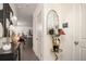 Inviting foyer with elegant mirror, stylish console table, and modern artwork leading into an open living space at 1296 Taylor Way, Stone Mountain, GA 30083