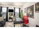 Bright home office featuring a black desk, red chair, and modern wall art at 1296 Taylor Way, Stone Mountain, GA 30083