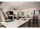Open-concept kitchen with a large island flowing into a living area featuring a fireplace and contemporary decor at 1296 Taylor Way, Stone Mountain, GA 30083