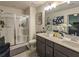 Elegant main bathroom with double sink vanity and glass enclosed shower at 1296 Taylor Way, Stone Mountain, GA 30083