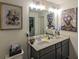 Charming bathroom featuring double sinks, decorative accents, and modern lighting fixtures at 1296 Taylor Way, Stone Mountain, GA 30083