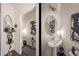 Stylish powder room featuring a pedestal sink, decorative mirror, and contemporary design at 1296 Taylor Way, Stone Mountain, GA 30083