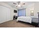 Bright bedroom with closet, plush carpet, a ceiling fan, and a wall-mounted TV at 173 Kingswood Dr, Ellenwood, GA 30294