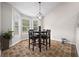 Sun-drenched dining area offers oversized windows and stylish hanging light fixture at 173 Kingswood Dr, Ellenwood, GA 30294