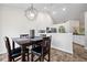 Open concept dining area with view to eat-in kitchen; lovely decorative touches at 173 Kingswood Dr, Ellenwood, GA 30294