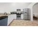 Well-lit kitchen with white cabinets, granite countertops, and stainless steel appliances at 173 Kingswood Dr, Ellenwood, GA 30294