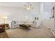 Spacious carpeted living room featuring high ceilings, a ceiling fan, and a comfortable sectional at 173 Kingswood Dr, Ellenwood, GA 30294