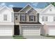 Charming townhome showcasing stone accents, a two-car garage, and a welcoming front entrance at 20 Jacobs Farm Ln # 10, Lawrenceville, GA 30045