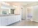 Bright bathroom featuring double vanity, granite countertops, tiled floors, and a view into another room at 2349 Hanover Woods Rd, Lithonia, GA 30058