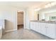 Bathroom featuring double vanity, granite countertops, tiled floor, and a walk-in closet at 2349 Hanover Woods Rd, Lithonia, GA 30058