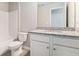 Well-lit bathroom featuring a granite-topped vanity, toilet, and shower/tub at 2349 Hanover Woods Rd, Lithonia, GA 30058