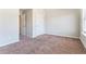 An empty carpeted bedroom with light walls and open doorway to the rest of the house at 2349 Hanover Woods Rd, Lithonia, GA 30058