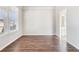 Well-lit bedroom with hardwood floors, neutral walls, and a large window, providing a cozy and inviting space at 2349 Hanover Woods Rd, Lithonia, GA 30058