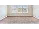 A carpeted bedroom with a large window letting in lots of natural light at 2349 Hanover Woods Rd, Lithonia, GA 30058