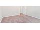 An airy bedroom with a view of the open doorway and carpeted floor at 2349 Hanover Woods Rd, Lithonia, GA 30058