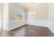 Elegant dining room with hardwood floors, wainscoting, and stylish chandelier, perfect for formal dinners at 2349 Hanover Woods Rd, Lithonia, GA 30058