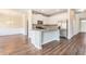 A lovely kitchen with white cabinets, stainless steel appliances, granite countertops, and new hardwood floors at 2349 Hanover Woods Rd, Lithonia, GA 30058
