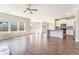 Open-concept living space with hardwood floors, a kitchen island, and ample natural light, perfect for entertaining at 2349 Hanover Woods Rd, Lithonia, GA 30058