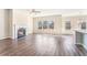 Open living room boasts a fireplace, hardwood floors, and ample natural light, perfect for relaxation and entertaining at 2349 Hanover Woods Rd, Lithonia, GA 30058