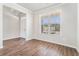 Bright living room features hardwood floors, large windows, and fresh paint, ready for your personal touch at 2349 Hanover Woods Rd, Lithonia, GA 30058