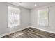 This bedroom features gray walls, wood-look flooring and bright windows at 313 Yancy Se Dr, Marietta, GA 30067