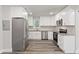 Modern kitchen with stainless steel appliances, granite countertops, and white cabinets at 313 Yancy Se Dr, Marietta, GA 30067