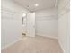 Walk-in closet with wire shelving and a view into the en-suite bathroom at 5587 Rosehall Pl, Atlanta, GA 30349