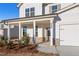 Inviting front entrance features a covered front porch with brick accents and a well landscaped yard at 5587 Rosehall Pl, Atlanta, GA 30349