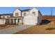 Charming two-story home features a covered front porch, a two car garage and professionally landscaped yard at 5587 Rosehall Pl, Atlanta, GA 30349