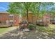 Backyard view showcasing the decks of neighboring brick townhomes at 91 Davis Mill Ct, Lawrenceville, GA 30044