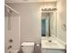 Well-lit bathroom featuring a shower and bath combo and a large vanity mirror at 91 Davis Mill Ct, Lawrenceville, GA 30044