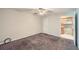 Neutral bedroom leading to kitchen, featuring plush carpet and a ceiling fan at 91 Davis Mill Ct, Lawrenceville, GA 30044