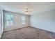 Light-filled bedroom features plush carpeting, neutral walls, and updated ceiling fan at 91 Davis Mill Ct, Lawrenceville, GA 30044