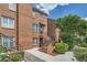 Well-maintained brick townhouse with landscaped front yard, offering a warm and inviting entrance at 91 Davis Mill Ct, Lawrenceville, GA 30044
