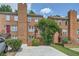 Brick townhouse with lush landscaping, offering a serene and inviting curb appeal at 91 Davis Mill Ct, Lawrenceville, GA 30044