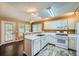 Eat-in kitchen with white cabinets, modern appliances, and a seamless transition to the dining area at 91 Davis Mill Ct, Lawrenceville, GA 30044