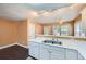 Bright kitchen featuring white cabinets, stainless steel sink and updated lighting fixtures at 91 Davis Mill Ct, Lawrenceville, GA 30044