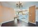 Open-concept kitchen with white cabinets, modern appliances, and hardwood floors at 91 Davis Mill Ct, Lawrenceville, GA 30044