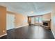 Open living room with hardwood floors, a brick fireplace, and bright, neutral walls at 91 Davis Mill Ct, Lawrenceville, GA 30044