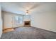 Bright living room featuring a brick fireplace, plush carpet and a ceiling fan at 91 Davis Mill Ct, Lawrenceville, GA 30044