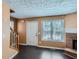 Cozy living room featuring a brick fireplace, hardwood floors, and ample natural light at 91 Davis Mill Ct, Lawrenceville, GA 30044