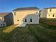 A flat backyard featuring a patio with a grass lawn and a retaining wall at 11045 Shadow Creek Ter, Hampton, GA 30228
