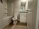 Bathroom featuring modern fixtures, a shower-tub combo, laminate flooring, and granite countertops at 11045 Shadow Creek Ter, Hampton, GA 30228