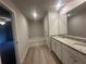 Bathroom with a soaking tub, a double vanity with granite countertops, and wood-look flooring at 11045 Shadow Creek Ter, Hampton, GA 30228