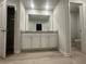 Bright bathroom featuring a double vanity, granite countertops, and wood-look flooring at 11045 Shadow Creek Ter, Hampton, GA 30228
