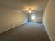 Large bedroom with neutral walls, carpet flooring, ceiling fan, and a window for natural light at 11045 Shadow Creek Ter, Hampton, GA 30228