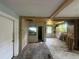 Renovation opportunity in a spacious living room with exposed ceiling beams and multiple windows at 1417 Richland Rd, Atlanta, GA 30310