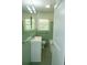 The bathroom features a green tile and a modern white vanity at 1468 North Amanda Cir, Atlanta, GA 30329